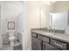 Clean bathroom featuring a granite countertop, vanity with a toilet and shower with a neutral-tone curtain at 14018 Promenade Dr, Huntersville, NC 28078