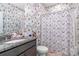 Beautiful bathroom boasting unique floral wallpaper, shower, toilet and granite countertop at 14018 Promenade Dr, Huntersville, NC 28078