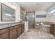 Bright bathroom with double vanity, granite countertop, soaking tub, and glass enclosed shower at 14018 Promenade Dr, Huntersville, NC 28078