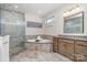 Inviting bathroom with a soaking tub, glass shower, granite counters, and tile flooring at 14018 Promenade Dr, Huntersville, NC 28078