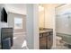 Bright bathroom featuring granite countertop vanity, a mirror, and toilet with shower at 14018 Promenade Dr, Huntersville, NC 28078