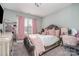 Charming bedroom featuring soft pink accents, plush carpet, and a window with natural light at 14018 Promenade Dr, Huntersville, NC 28078