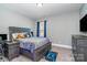 Comfortable bedroom featuring neutral walls, and a large window, filled with natural light at 14018 Promenade Dr, Huntersville, NC 28078