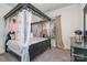 Stylish bedroom with a canopy bed, soft lighting, and a window bringing in natural light at 14018 Promenade Dr, Huntersville, NC 28078