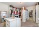 Expansive walk-in closet with custom shelving, drawers, and ample hanging space for luxury storage at 14018 Promenade Dr, Huntersville, NC 28078