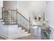 Bright foyer featuring a beautiful staircase with iron spindles and wood treads at 14018 Promenade Dr, Huntersville, NC 28078