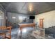 Basement game room featuring a pool table, mounted TV, and modern chairs at 14018 Promenade Dr, Huntersville, NC 28078