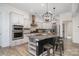 Modern kitchen boasts an island with bar seating, stainless steel appliances, and pendant lighting at 14018 Promenade Dr, Huntersville, NC 28078