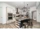 Modern kitchen boasts an island with bar seating, stainless steel appliances, and pendant lighting at 14018 Promenade Dr, Huntersville, NC 28078