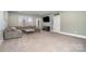 Large living room with an entertainment center, big windows, and comfortable gray sofa at 14018 Promenade Dr, Huntersville, NC 28078