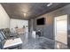 Basement living room with theater seating, wet bar, mounted television, and modern decor at 14018 Promenade Dr, Huntersville, NC 28078