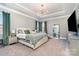 Spacious main bedroom with luxury bedding, green accents, and a decorative light fixture at 14018 Promenade Dr, Huntersville, NC 28078