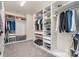 Spacious walk-in closet with custom built-in shelving and a convenient soaking tub at 14018 Promenade Dr, Huntersville, NC 28078