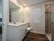 Bathroom with double sink vanity, modern fixtures, stylish mirror, and tiled shower with glass door at 14041 Castle Nook Dr # 75, Charlotte, NC 28273