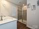 Updated bathroom featuring modern vanity with double sink and tiled glass shower with matte black hardware at 14041 Castle Nook Dr # 75, Charlotte, NC 28273