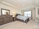 Bright bedroom features a tray ceiling, plush carpet, large window, and matching furniture set at 14041 Castle Nook Dr # 75, Charlotte, NC 28273