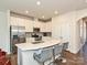 Bright kitchen with stainless steel appliances, white cabinetry, and bar stool seating at the island at 14041 Castle Nook Dr # 75, Charlotte, NC 28273