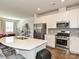 Contemporary kitchen with white cabinets, stainless steel appliances, and a spacious island for dining at 14041 Castle Nook Dr # 75, Charlotte, NC 28273