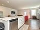 Modern kitchen featuring a white countertop island, stainless steel appliances, and an open layout to the living area at 14041 Castle Nook Dr # 75, Charlotte, NC 28273
