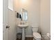 Well-lit powder room showcasing a pedestal sink, toilet, and neutral wall color at 14041 Castle Nook Dr # 75, Charlotte, NC 28273