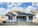Back of house shows a patio with multiple windows to let in ample sunlight at 148 Prestwick Way # 21, Mooresville, NC 28115