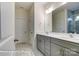 Bright bathroom features a double sink vanity with gray cabinets and a large mirror at 148 Prestwick Way # 21, Mooresville, NC 28115