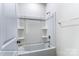 Bright bathroom featuring a white shower-tub and chrome fixtures and white walls at 148 Prestwick Way # 21, Mooresville, NC 28115