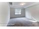 Neutral bedroom with tray ceiling, plush carpeting, and large window that fills the room with natural light at 148 Prestwick Way # 21, Mooresville, NC 28115