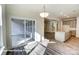 Open dining area with sliding glass door to patio, seamlessly connects to the modern kitchen with a large center island at 148 Prestwick Way # 21, Mooresville, NC 28115