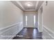 Inviting entryway featuring a white front door with sidelights, hardwood flooring, and white wainscoting at 148 Prestwick Way # 21, Mooresville, NC 28115