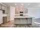 Bright kitchen with stainless appliances, granite countertops, gray cabinets and a spacious center island at 148 Prestwick Way # 21, Mooresville, NC 28115