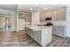 Modern kitchen featuring gray cabinets, subway tile backsplash, stainless appliances, and a large center island at 148 Prestwick Way # 21, Mooresville, NC 28115