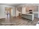 Open-concept kitchen with gray cabinets, subway tile backsplash, stainless appliances, and a large center island at 148 Prestwick Way # 21, Mooresville, NC 28115