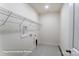 A clean and spacious laundry room with wire shelving and utility connections at 148 Prestwick Way # 21, Mooresville, NC 28115