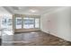 Open living room space with hardwood floors, white walls, and large windows at 148 Prestwick Way # 21, Mooresville, NC 28115