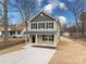 Two-story house with gray siding, a light-colored driveway, and mature trees in the yard at 1500 Collinston Dr, Gastonia, NC 28052