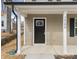 Modern front door with a glass window insert and white columns at 1500 Collinston Dr, Gastonia, NC 28052