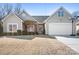 Tan house with a gray roof, brick accents, and a two-car garage at 160 Bluffton Rd, Mooresville, NC 28115