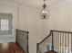 Elegant upstairs hallway with chandelier and railing at 208 Grasshopper Cir, Mooresville, NC 28117