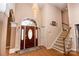 Elegant entryway with hardwood floors, a grand staircase, and a crystal chandelier at 219 Society Rd, Statesville, NC 28625