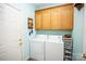Convenient laundry room with washer, dryer, and storage cabinets at 219 Society Rd, Statesville, NC 28625