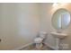 Convenient powder room with pedestal sink and oval mirror at 2226 Catawba Trace Dr, Catawba, NC 28609