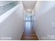 View down a light-filled hallway showcasing a staircase and access to other rooms at 2573 Ruby Dixon Crossing Dr # 13, Gastonia, NC 28056