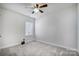 Simple bedroom with ceiling fan and neutral color palette at 301 Tomberlin Rd, Mount Holly, NC 28120