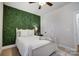 Cozy bedroom featuring a green accent wall and ceiling fan at 301 Tomberlin Rd, Mount Holly, NC 28120