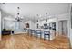 Open concept kitchen and dining area with hardwood floors and island seating at 301 Tomberlin Rd, Mount Holly, NC 28120