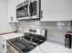 Stainless steel appliances and gray tile backsplash in this modern kitchen at 301 Tomberlin Rd, Mount Holly, NC 28120