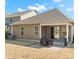 Home's rear exterior view showcasing patio, tidy landscaping, and neighboring houses at 3029 Mendenhall St, Indian Trail, NC 28079