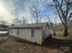 Tan house with vinyl siding, a back yard, and mature trees at 351 Haigler St, Rock Hill, SC 29732