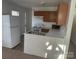 L-shaped kitchen with oak cabinets and white appliances at 351 Haigler St, Rock Hill, SC 29732